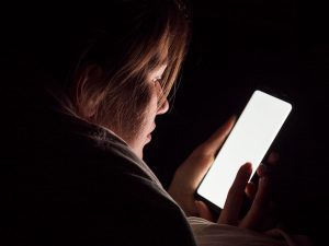 Jugendlicher reflektiert Medienkonsum am Smartphone